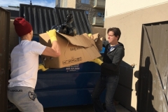 Heave-ho! Throwing trash from the storage unit away.