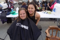 Tammy smiles with a homeless woman after cutting her hair for Easter.