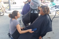 Asking a homeless lady how she wants her hair styled and cut.