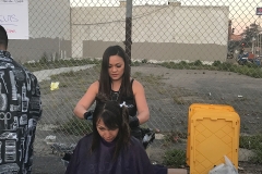 Tammy hard at work cutting a homeless lady's hair