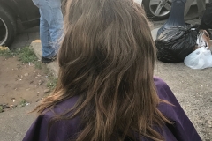 A homeless women getting her haircut at our homeless special event.