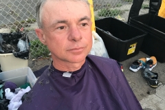 A homeless man looking great after his haircut.