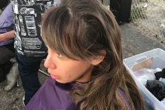 Homeless woman gets her hair cut.