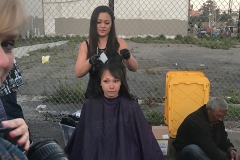 Tammy cuts a homeless women's hair at our homeless special event.