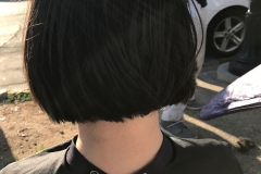 The back of Angel's head as Tammy cuts her hair