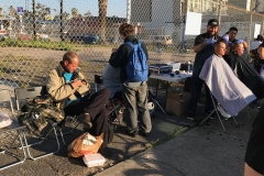 The homeless line up for haircuts at our special event