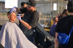 Eric from the Country Club Barber Shop cuts a homeless man's hair