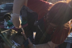 Kat giving a profession hair cut to a homeless women at our San Diego Easter event