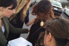 Praying for a San Diego homeless women during our Easter homeless event