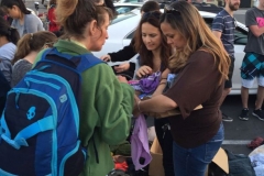 During Easter Michelle and Suzy helping Rachael, who is homeless, find her size with the clothing.