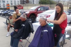 Laura and Tammy cutting hair for the homeless in downtown San Diego.