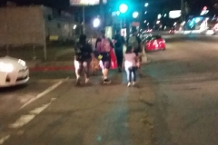 A homeless family walks away after being fed and clothed by the Streets of Hope.