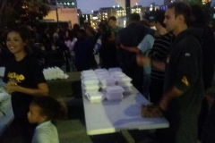 Volunteer Nate helping prepare food trays to feed San Diego's homeless.
