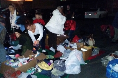 Jackie prepares a donated pair of running shoes from RoadRunnerSports.com for a homeless women.