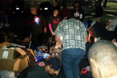 A San Diego homeless man being helped by Streets of Hope volunteers to find new clothes and shoes.