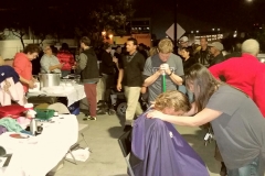 Tammy and Parker praying for a San Diego homeless women after she cut her hair at our homeless Thanksgiving event.
