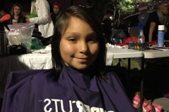 Rickie, a little San Diego homeless girl smiles after her hair is cut - AFTER PHOTO.