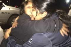 Rickie, a homeless San Diego girl, hugs Arul after she gives Rickie a Spiderman backpack.