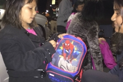Wait, Rickie, a little homeless girl, suddenly realizes there's something in the backpack from Arul.