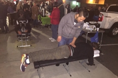 Chiropractor Jeremy adjusts a homeless man's back during our Christmas event.