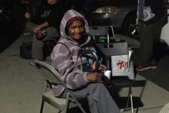 A downtown San Diego homeless women smiles as she waits for her hair cut.