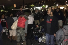 A Streets of Hope San Diego volunteer helps a homeless woman find some clothing.