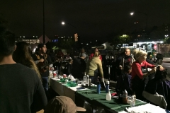 Mark has his guitar and is singing Christmas songs while Streets of Hope San Diego volunteers cut hair.