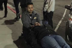 Jeremy, homeless chiropractor, adjusts a homeless man's neck in downtown San Diego.