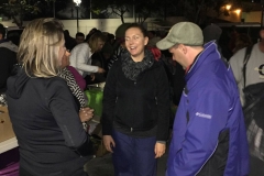 Tammy and other Streets of Hope volunteers giving new sneakers to a San Diego homeless man.