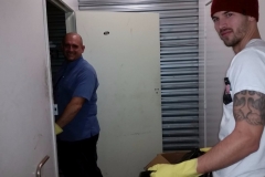 Eric and Joe cleaning out the dirt and muck from the homeless storage unit.