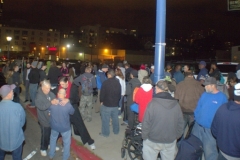 Many homeless people lining up to receive food on the streets in downtown San Diego.