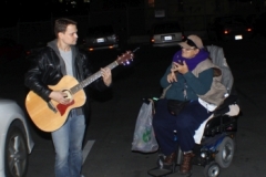 Chris sings a worship song as homeless woman Dorthy sings along.