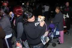 A homeless women in San Diego holds up her dog on the streets of San Diego.