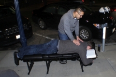 Dr Jeremy gives a professional chiropractic session to a homeless man.