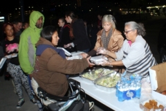 Christina and Michelle pass out food to the homeless on the streets.