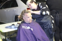 A homeless man has his hair cut by a Streets of Hope volunteer.