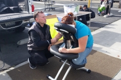 David massages a homeless women's back at the Streets of Hope Easter Event