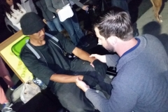 Dr. Eric gives a homeless man a chiropractic adjustment at our Easter event