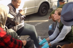 Anne washes a homeless woman's feet on the streets of downtown San Diego.