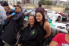 Tammy and a homeless women smile before she gives her a hair cut.