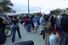 The homeless line up for food on Easter.