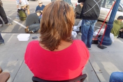 A homeless women waits to have her hair cut on Easter.