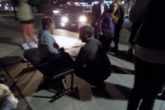 The light shines on Dr. Eric and a homeless women as he prepares to help her.