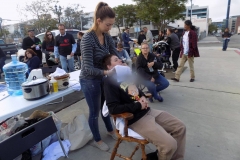 Serena prepares a hot towel for a homeless women as she starts another facial.