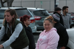 Anne helps a homeless women in the foreground, as Jackie listens to a homeless man in the background.