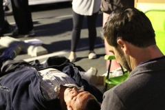Dr. Eric prepares a homeless man for his chiropractic services on Easter.