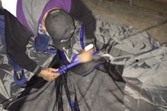 Homeless man Stacy building his new tent we just bought him.