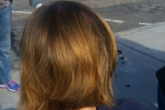 The back of a homeless woman's hair AFTER the Streets of Hope cut his hair.