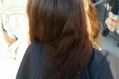 A homeless woman getting her hair cut.