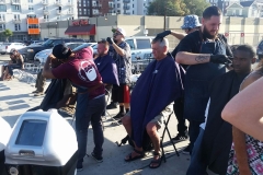 The incredible men of the Country Club Barber Shop cutting the hair of the homeless downtown.